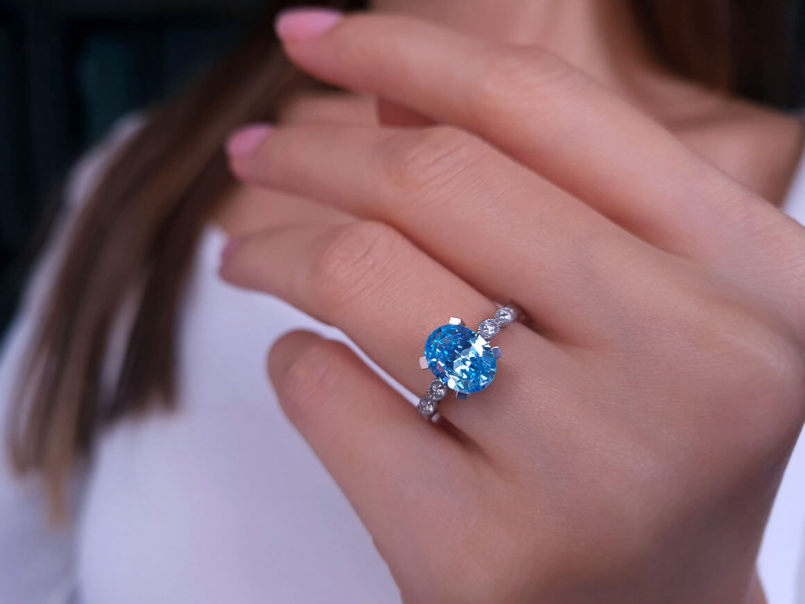 Diamond and Oval Blue Topaz Ring