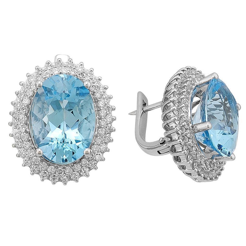 Diamond and Oval Cut Blue Topaz Stud Earrings